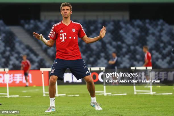 Thomas Mueller of FC Bayern Muenchen jokes with his team mates during a training session at Shenzhen Universiade Sports Centre during the Audi Summer...