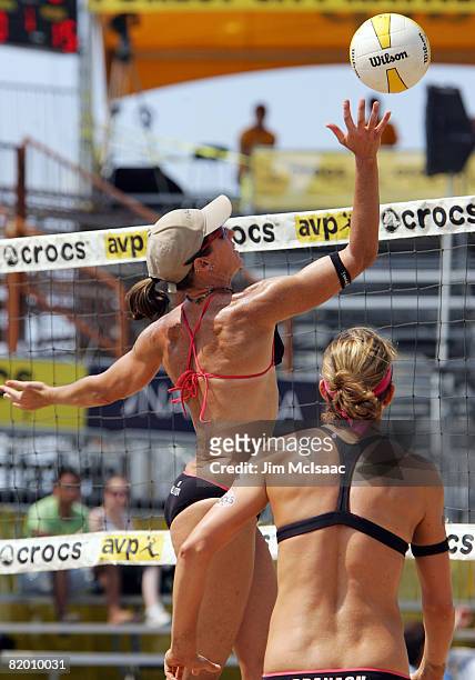 Elaine Youngs tips a shot over the net as teammate Nicole Branagh looks on during the women's quarter-finals of the AVP Brooklyn Open on July 20,...