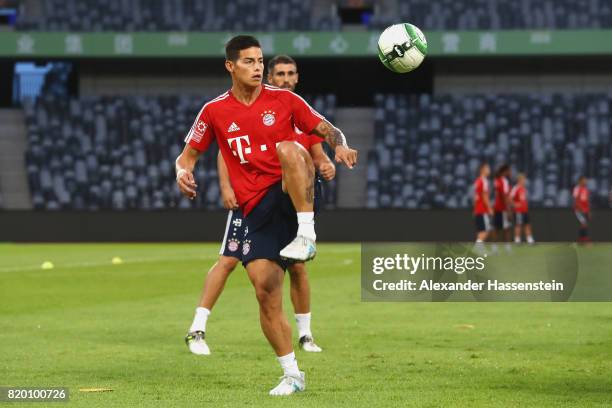 James Rodriguez of FC Bayern Muenchen battles for the ball during a training session at Shenzhen Universiade Sports Centre during the Audi Summer...