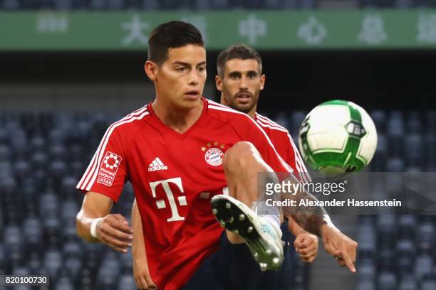 James Rodriguez of FC Bayern Muenchen battles for the ball during a training session at Shenzhen Universiade Sports Centre during the Audi Summer...