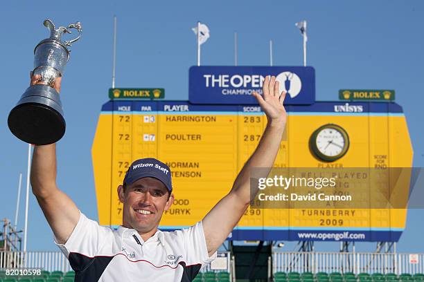 Padraig Harrington of the Republic of Ireland celebrates with the Claret Jug in front of the scoreboard after winning by 4 strokes during the final...