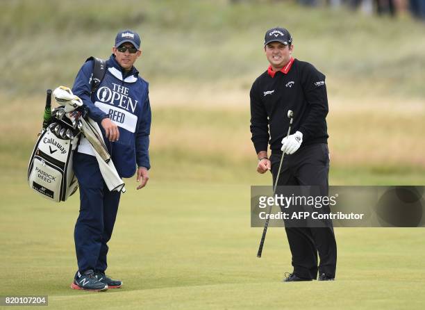Golfer Patrick Reed and his caddie Kessler Karain wait on the 8th fairway during his second round on day two of the Open Golf Championship at Royal...