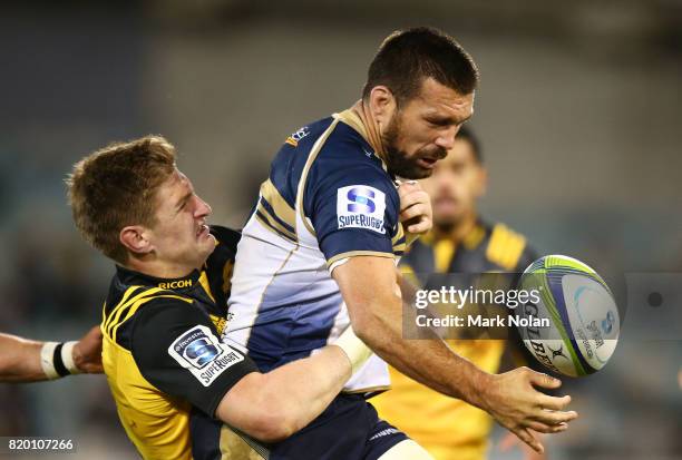 Chris Alcock of the Brumbies loses the ball in a tackle by Jordie Barrett of the Hurricanes during the Super Rugby Quarter Final match between the...