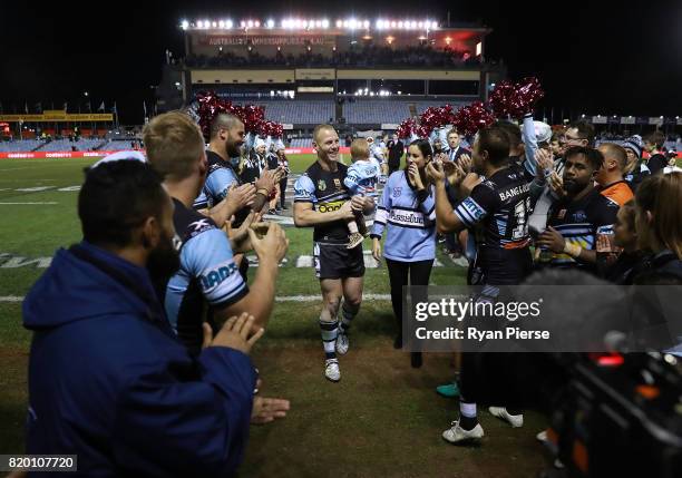 Luke Lewis of the Sharks celebrates after his 300th NRL match during the round 20 NRL match between the Cronulla Sharks and the South Sydney...