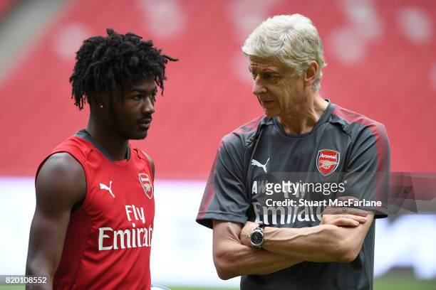 Arsenal manager Arsen Wenger talks to Ainsley Maitland-Niles during a training session at the Birds Nest stadium on July 21, 2017 in Beijing, China.
