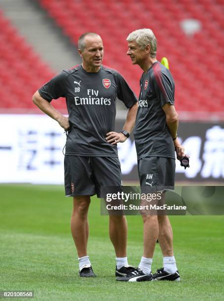 Arsenal manager Arsene Wenger with fitness coach Darren Burgess during a training session at the Birds Nest stadium on July 21, 2017 in Beijing,...