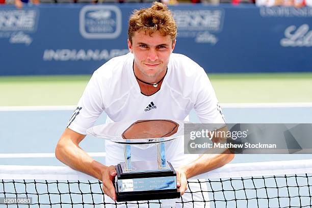 Gilles Simon of France poses for photographers after defeating Dmitry Tursunov of Russia during the final of the Indianapolis Tennis Championships at...