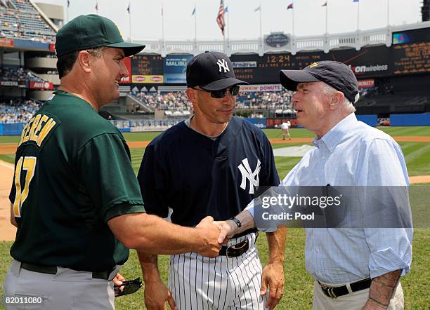 Republican presidential candidate Sen. John McCain talks with managers Bob Geren of the Oakland Athletics and Joe Girardi of the New York Yankees...