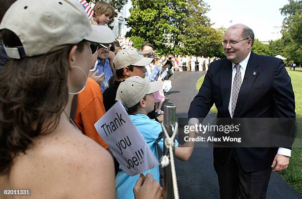 White House Deputy Chief of Staff Joe Hagin shakes hands with White House staff and their families after he returned to the White House from...