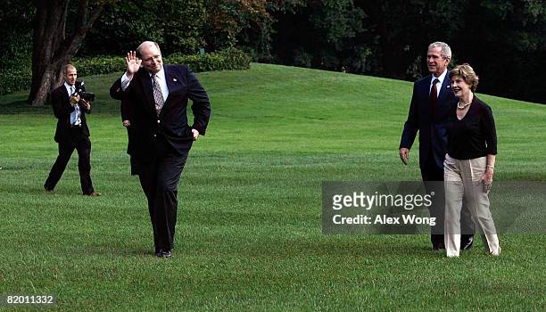 White House Deputy Chief of Staff Joe Hagin waves as U.S. President George W. Bush and First Lady Laura Bush look on after they returned to the White...