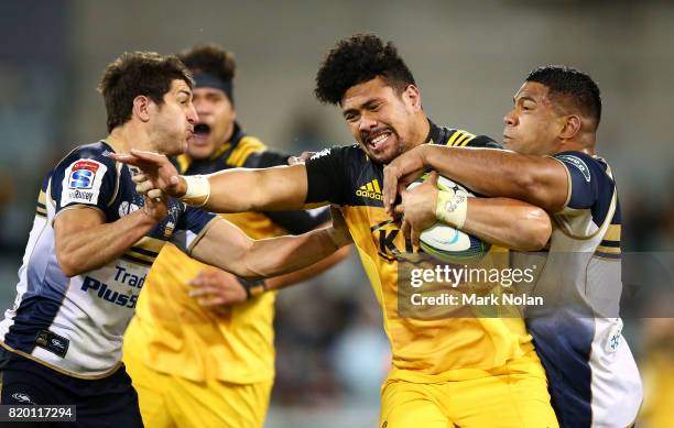 Ardie Savea of the Hurricanes is tackled during the Super Rugby Quarter Final match between the Brumbies and the Hurricanes at Canberra Stadium on...