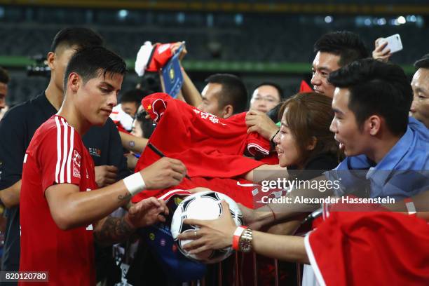 James Rodriguez of FC Bayern Muenchen signs autographs after a training session at Shenzhen Universiade Sports Centre during the Audi Summer Tour...