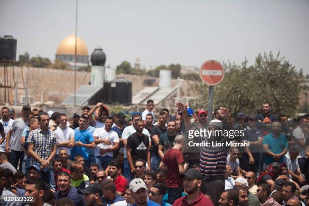 Palestinian worshippers are seen during a pray in Ras el-Amud Area outside the Old City on July 21, 2017 in Jerusalem, Israel. Following last Friday...