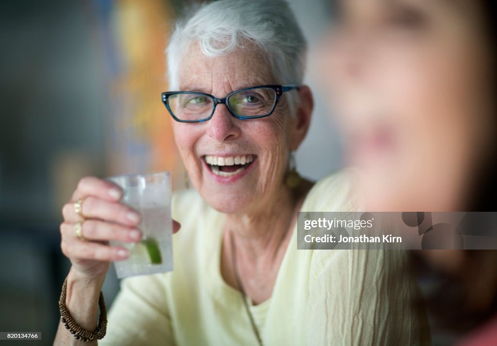 Senior woman has a drink.