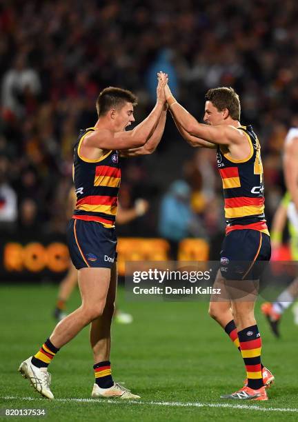 Riley Knight and Matt Crouch of the Crows celebrate after the final siren during the round 18 AFL match between the Adelaide Crows and the Geelong...