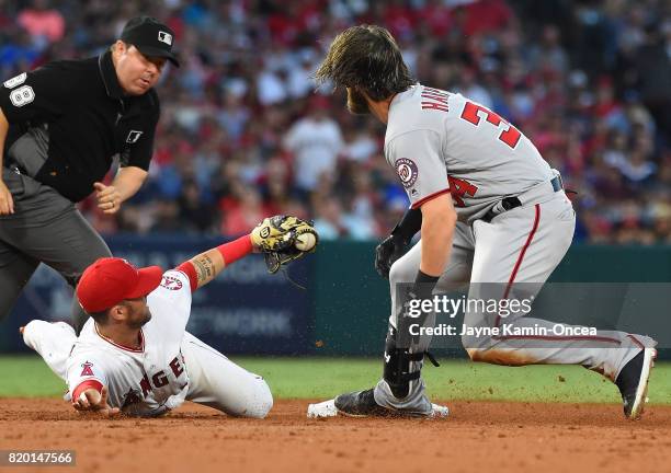 Bryce Harper of the Washington Nationals is tagged out at second base by Nick Franklin of the Los Angeles Angels as he was going for a double in the...