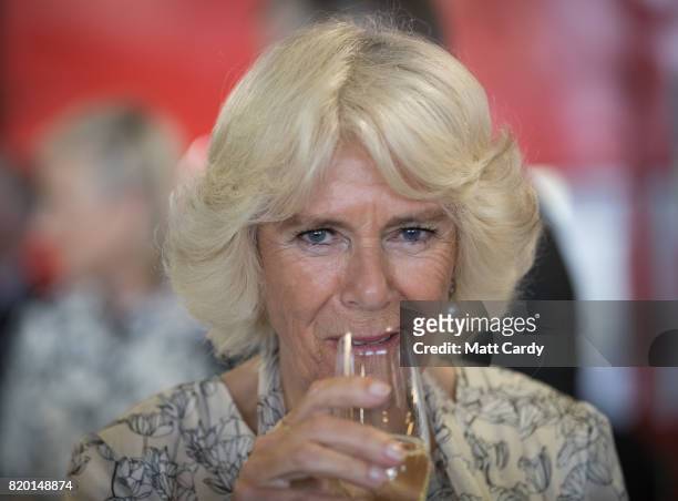 Camilla, Duchess of Cornwall tastes a locally produced wine at Newquay Fire Station as she meets residents from Tregunnel Hill, a mixed-use...