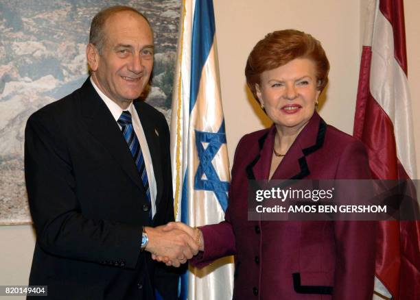 In this image made available by the Israeli Government Press office 21 February 2006, Deputy Prime Minister Ehud Olmert shakes hands with Latvian...