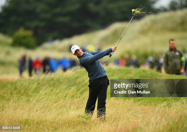 Rory McIlroy of Northern Ireland hits his second shot from the rough on the 13th hole during the second round of the 146th Open Championship at Royal...