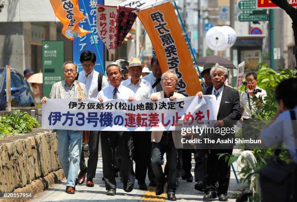 Plaintiffs and their supporters gather in front of the Matsuyama District Court to hear the court verdict over the request for a temporary injunction...