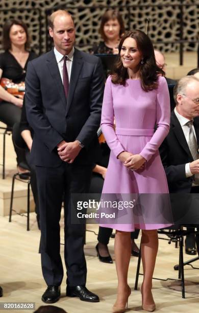 Prince William, Duke of Cambridge and Catherine, Duchess of Cambridge receive a quick lesson to conduct an orchestra at Elbphilharmonie during day...