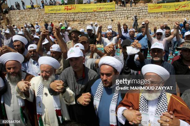 Lebanese Sunni and Shiite clergymen participate in Friday prayers at the "Garden of Iran" Park, which was built by the Iranian government, in Maroun...