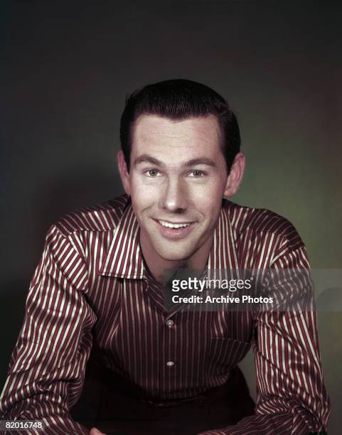American comedian and television presenter Johnny Carson wearing a red and white striped silk shirt, circa 1960.