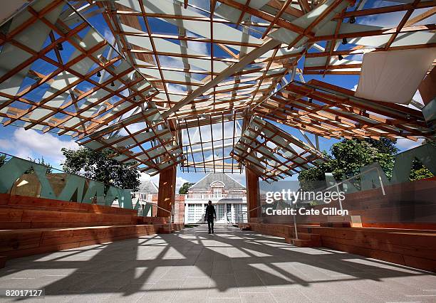 Members of the public enjoy the Serpentine Gallery Pavilion 2008, which is a wooden timber structure designed by the architect Frank Gehry on July...