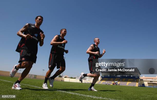 Sunderland players Carlos Edwards, Michael Chopra and Roy O'Donovan warm up during a team training session at the Estadio Da Nora on July 21, 2008 in...