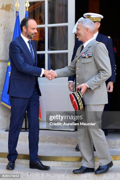 Army Commander in Chief General Francois Lecointre and French Prime Minister Edouard Philippe shake hand after a meeting at Hotel Matignon on July...