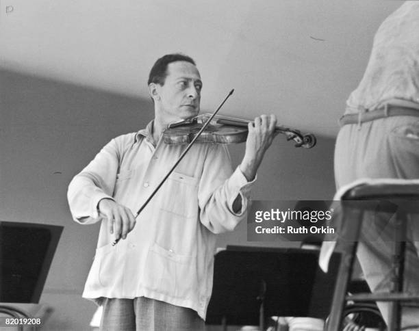 Lithuanian-born American violinist Jascha Heifetz plays during rehearsals at Tanglewood, a large estate given to the Boston Symphony Orchestra for a...