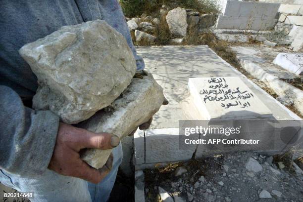 Worker carries stones past a family gravesite of the Palestinian leader Yasser Arafat, just outside the eastern walls of Jerusalem's Old City, 07...