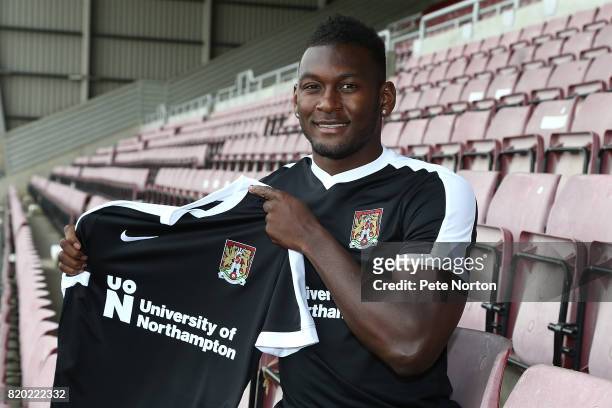 Northampton Town new signing Aaron Pierre poses with a shirt during a photo call at Sixfields on July 21, 2017 in Northampton, England.