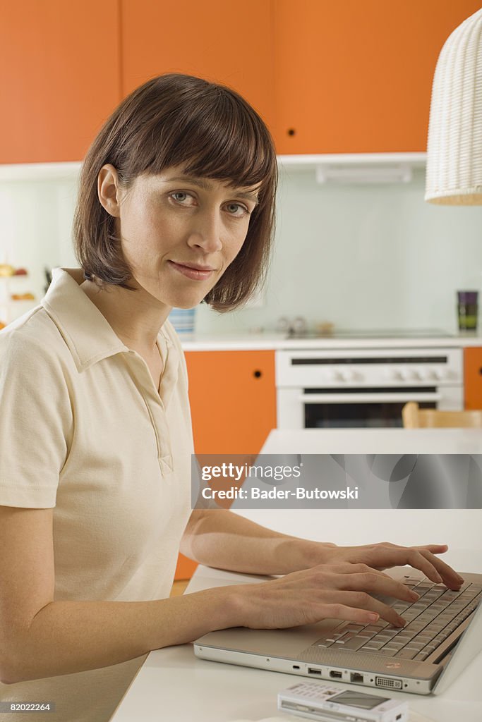 Young woman using laptop, portrait