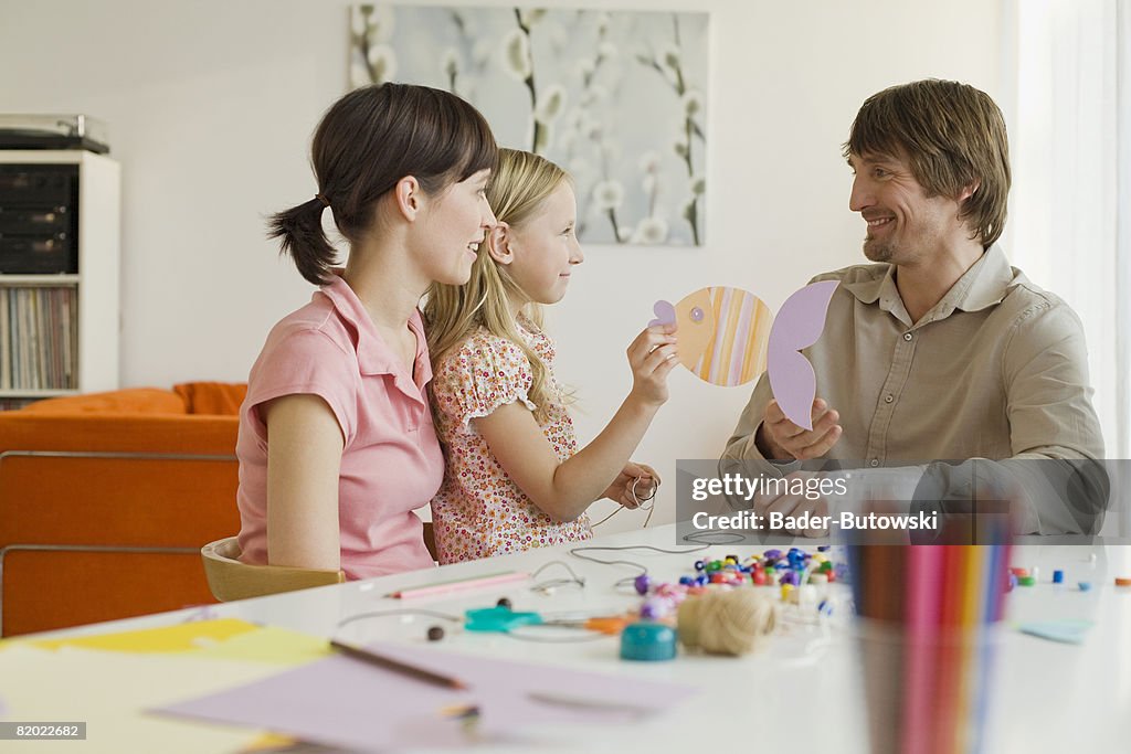 Parents playing with daughter (8-9)