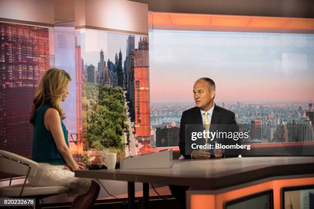 Michael Moe, chief executive officer of GSV Capital Corp., right, speaks during a Bloomberg Television interview in New York, U.S., on Friday, July...