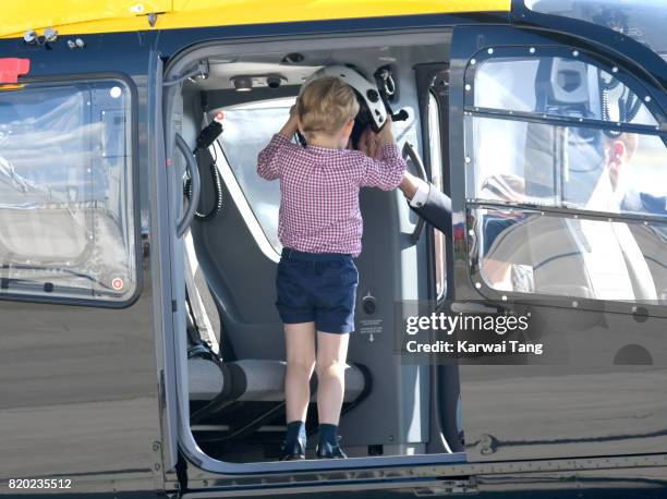 Prince George of Cambridge views helicopter models H145 and H135 before departing from Hamburg airport on the last day of their official visit to...