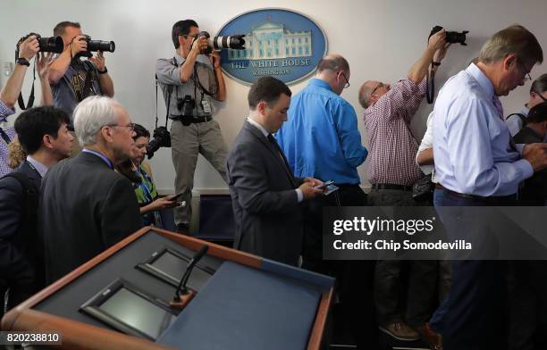 Journalists crowd the entrance to the White House press office after it was learned that Press Secretary Sean Spicer has resigned July 21, 2017 in...