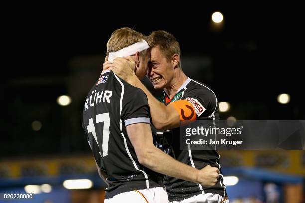 Christopher Ruhr of Germany celebrates scoring the winning the penalty with Mats Grambusch of Germany during the semi-final match between Spain and...