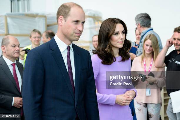 Prince William, Duke of Cambridge and Catherine, Duchess of Cambridge take a tour of Airbus before taking their children to see helicopter models...