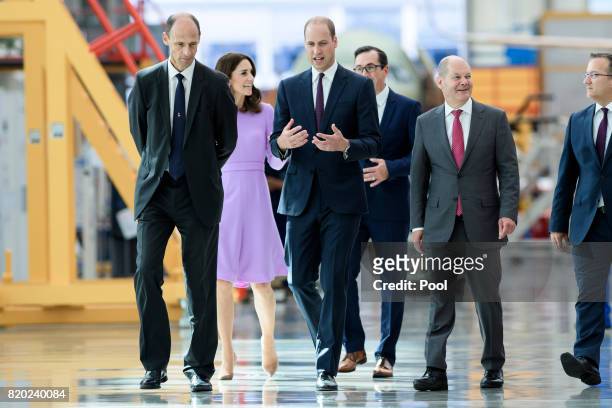 First Mayor of Hamburg Olaf Scholz walks with Prince William, Duke of Cambridge and Catherine, Duchess of Cambridge as they take a tour of Airbus...