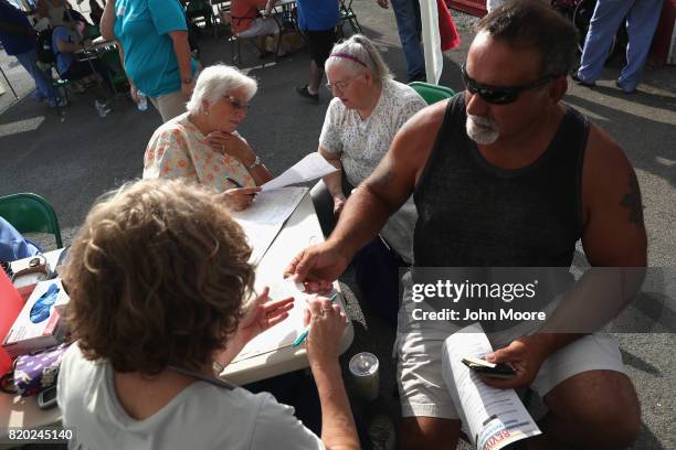 Patients prepare to receive free medical services at the Remote Area Medical mobile clinic on July 21, 2017 in Wise, Virginia. RAM holds the...