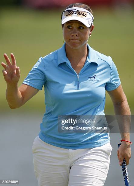 Eathorne from Canada waves to fans after a birdie on the 17th hole during the first round of the State Farm Classic at Panther Creek Country Club on...