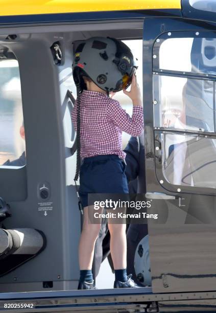 Prince George of Cambridge views helicopter models H145 and H135 before departing from Hamburg airport on the last day of their official visit to...