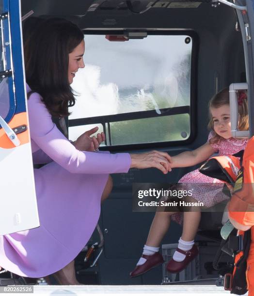 Princess Charlotte of Cambridge and Catherine, Duchess of Cambridge view a helicopter as htey depart from Hamburg airport on the last day of their...