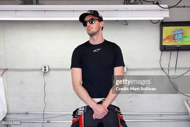 Ben Kennedy, driver of the Weber Chevrolet, stands in the garage area during practice for the NASCAR XFINITY Series Lilly Diabetes 250 at...