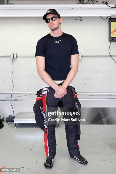 Ben Kennedy, driver of the Weber Chevrolet, stands in the garage area during practice for the NASCAR XFINITY Series Lilly Diabetes 250 at...