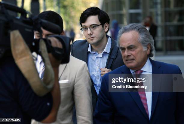 Martin Shkreli, former chief executive officer of Turing Pharmaceuticals AG, center, exits federal court with his attorney Benjamin Brafman, right,...