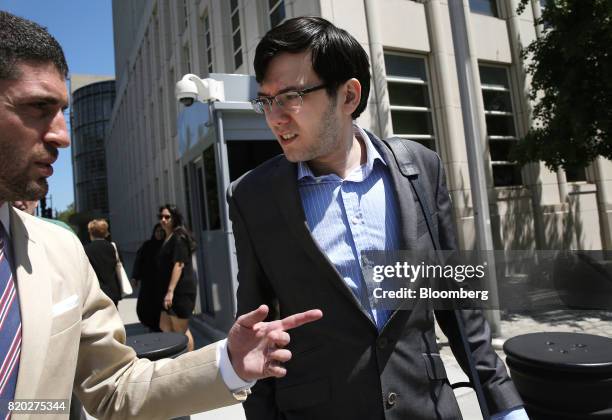 Martin Shkreli, former chief executive officer of Turing Pharmaceuticals AG, right, exits federal court in the Brooklyn borough of New York, U.S., on...