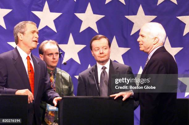 Gov. George W. Bush, left, Gary Bauer, center, and Sen. John McCain, right, settle in before the start of the Republican Candidates Debate in Durham,...